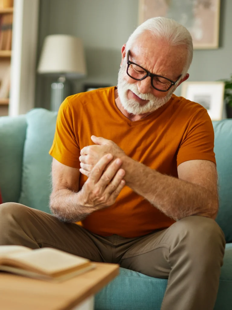 Older man suffering from clear nerve pain in hand